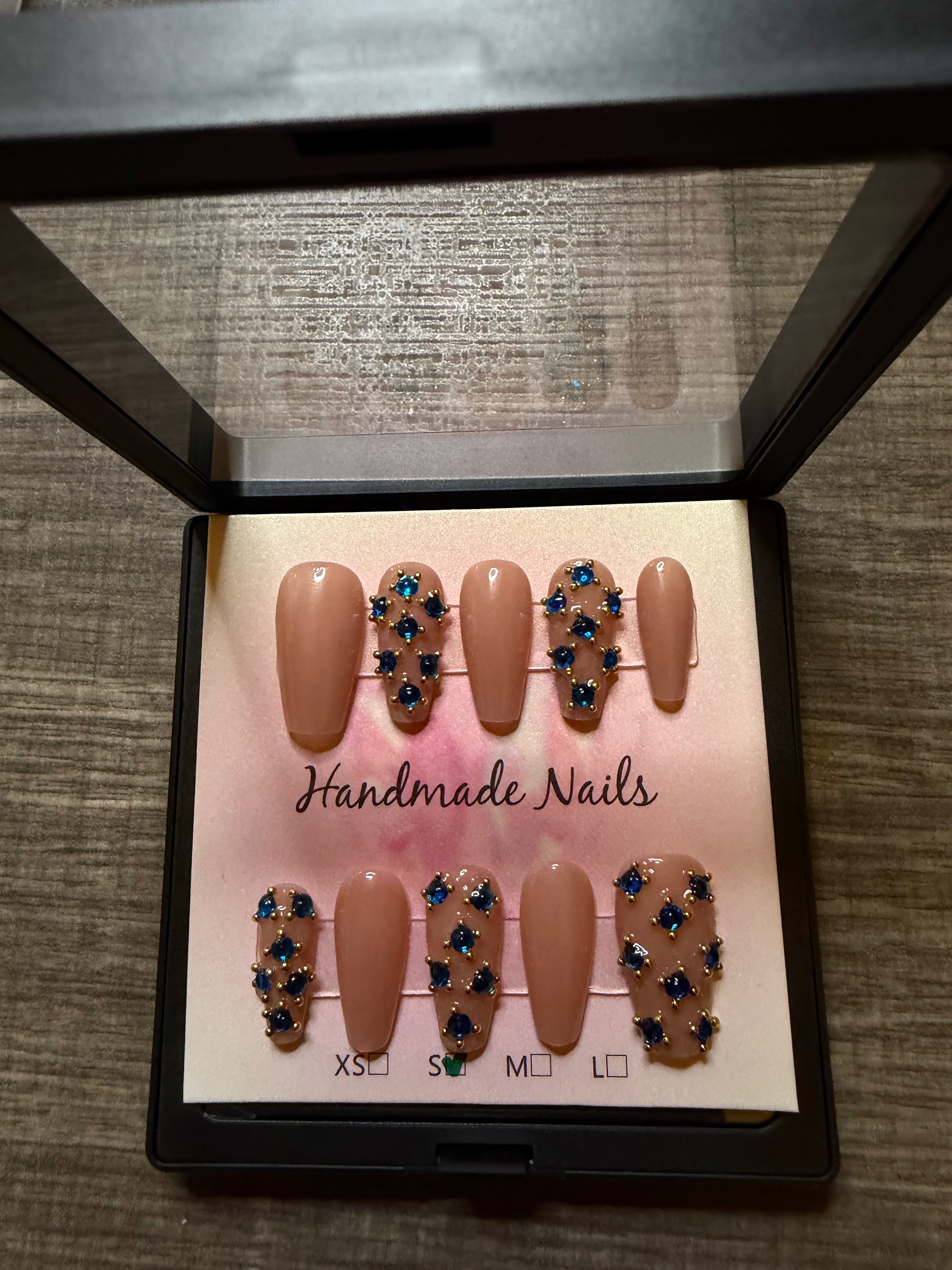Sapphire Socialite nude press on nails with blue rhinestones