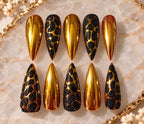 Golden Goddess handmade press-on nails with reflective gold chrome and black textured statement pattern