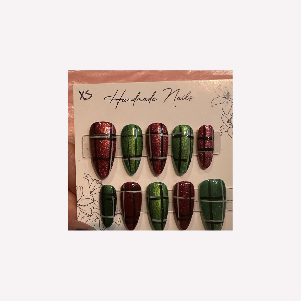 Festive red and green shimmering plaid nail art.