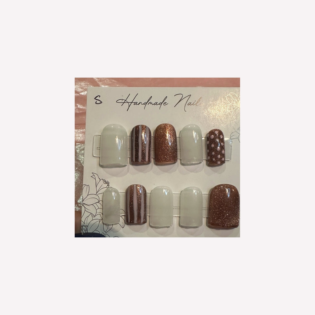 Soft ivory and rose-gold glitter with delicate stripes and polka-dot accents.