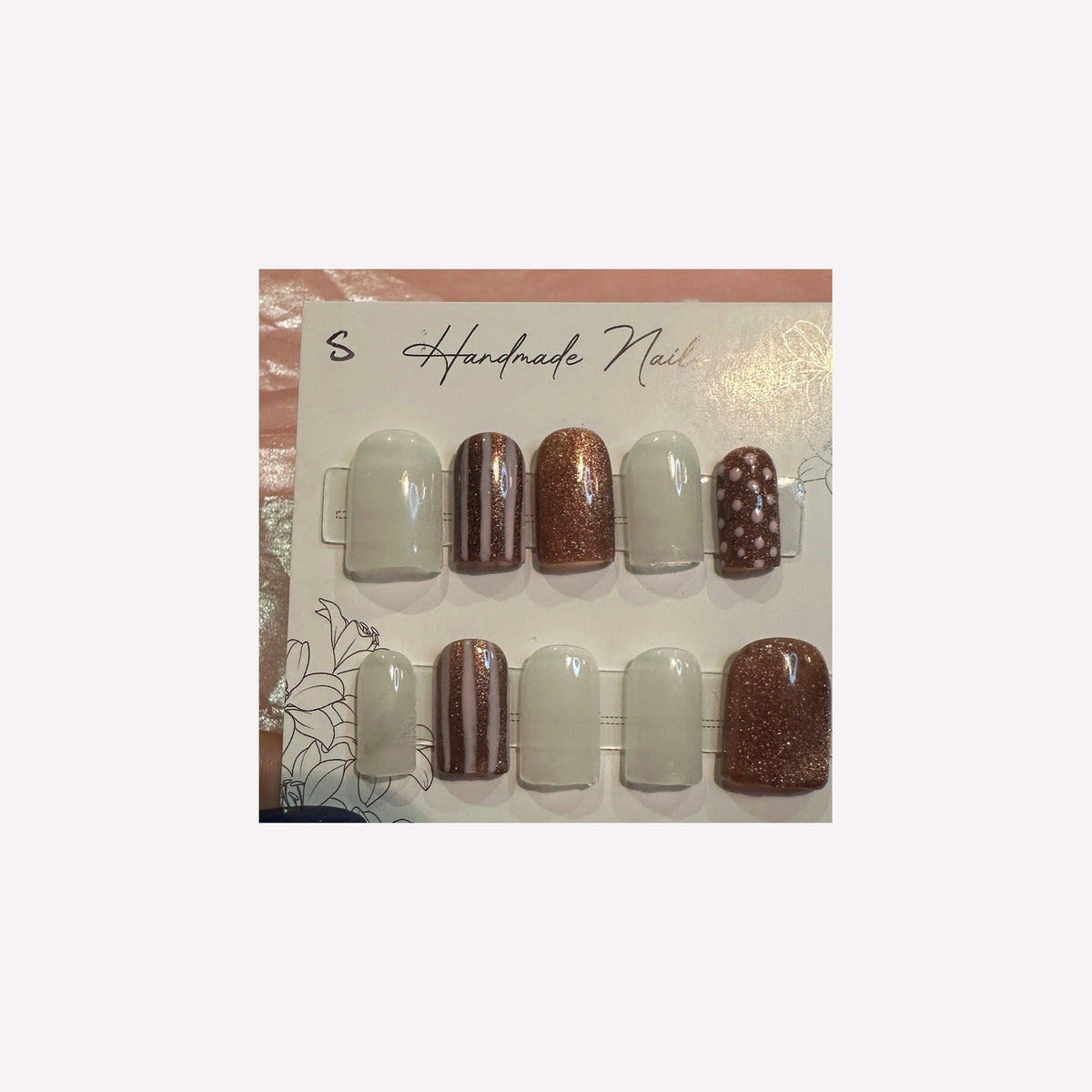 Soft ivory and rose-gold glitter with delicate stripes and polka-dot accents.
