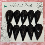Close-up of Midnight Glitter Claws press-on nail set