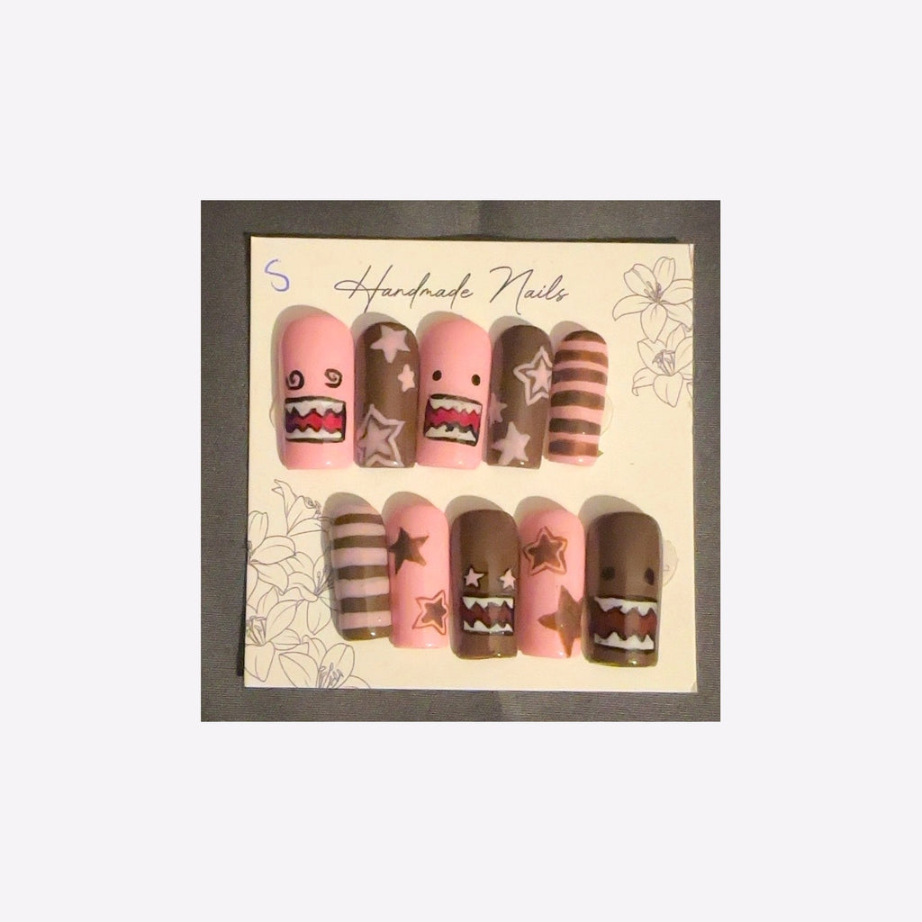 Playful pink and cocoa-brown cartoon monster faces, whimsical stars, and coordinating stripes.