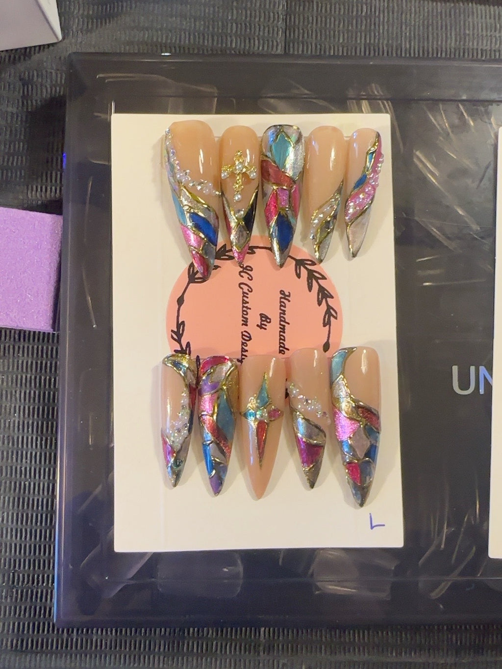 Prism Luxe handmade press-on nails with nude base, multicolor stained-glass details, metallic accents and crystals
