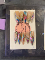 Prism Luxe handmade press-on nails with nude base, multicolor stained-glass details, metallic accents and crystals