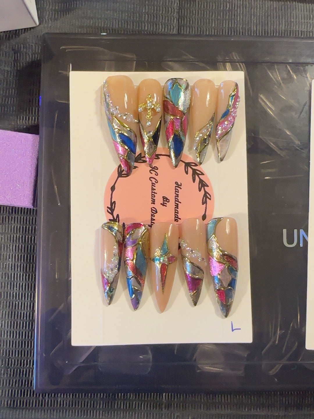 Prism Luxe handmade press-on nails with nude base, multicolor stained-glass details, metallic accents and crystals