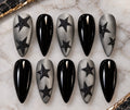 Rockstar handmade press-on nails with glossy black nails and smoky grey nails with black glitter stars