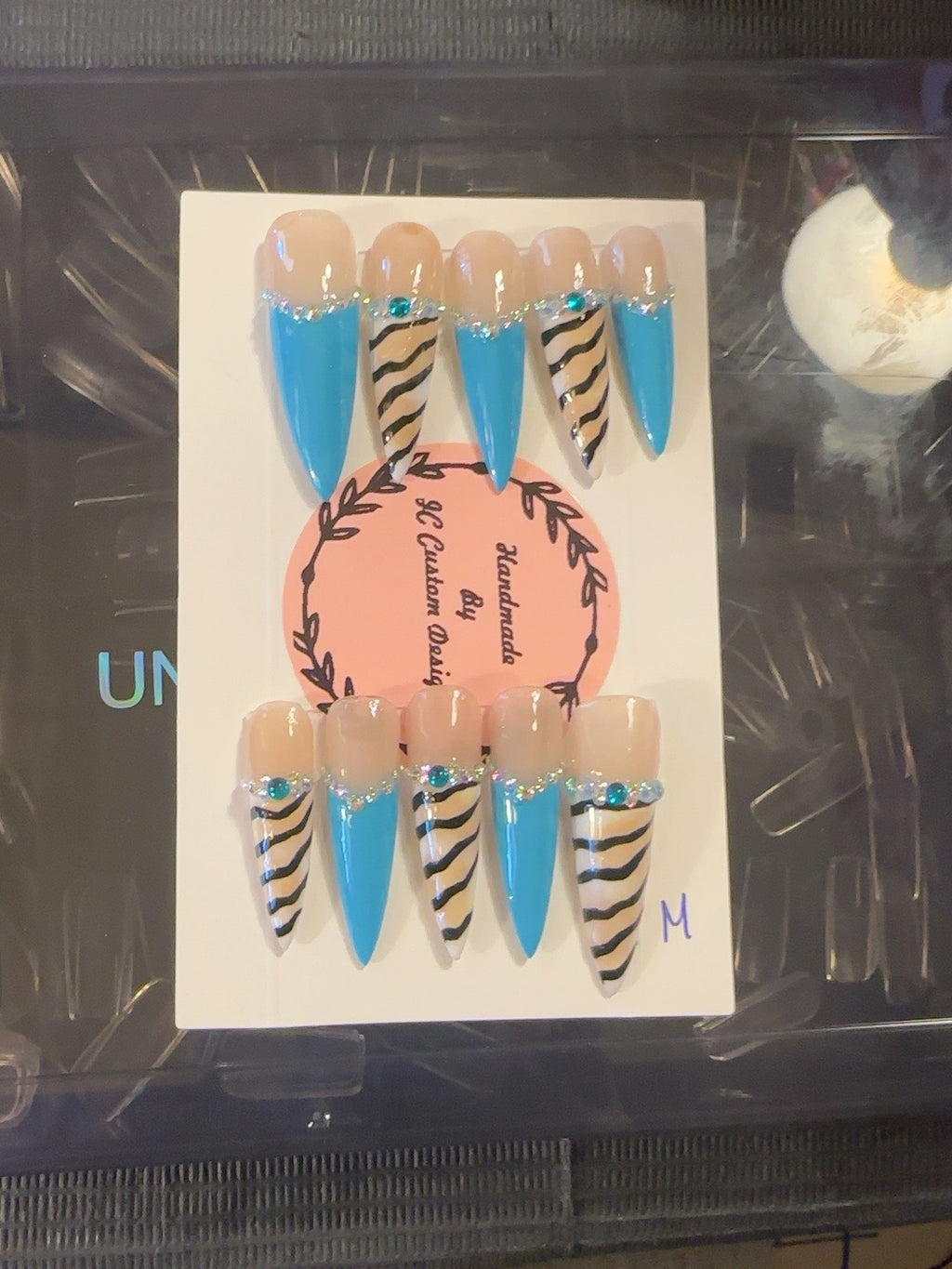 Turquoise Wild handmade press-on nails with bright turquoise French tips, nude zebra print and crystal accents