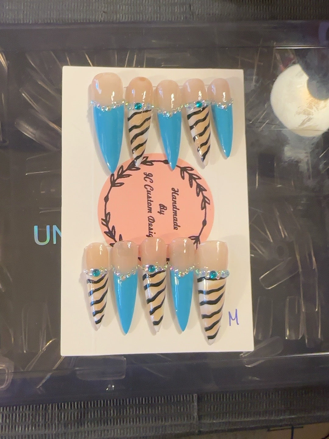 Turquoise Wild handmade press-on nails with bright turquoise French tips, nude zebra print and crystal accents