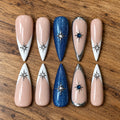 Under the Stars handmade press-on nails with nude, white French tips, blue glitter, silver chrome and starburst crystal accents