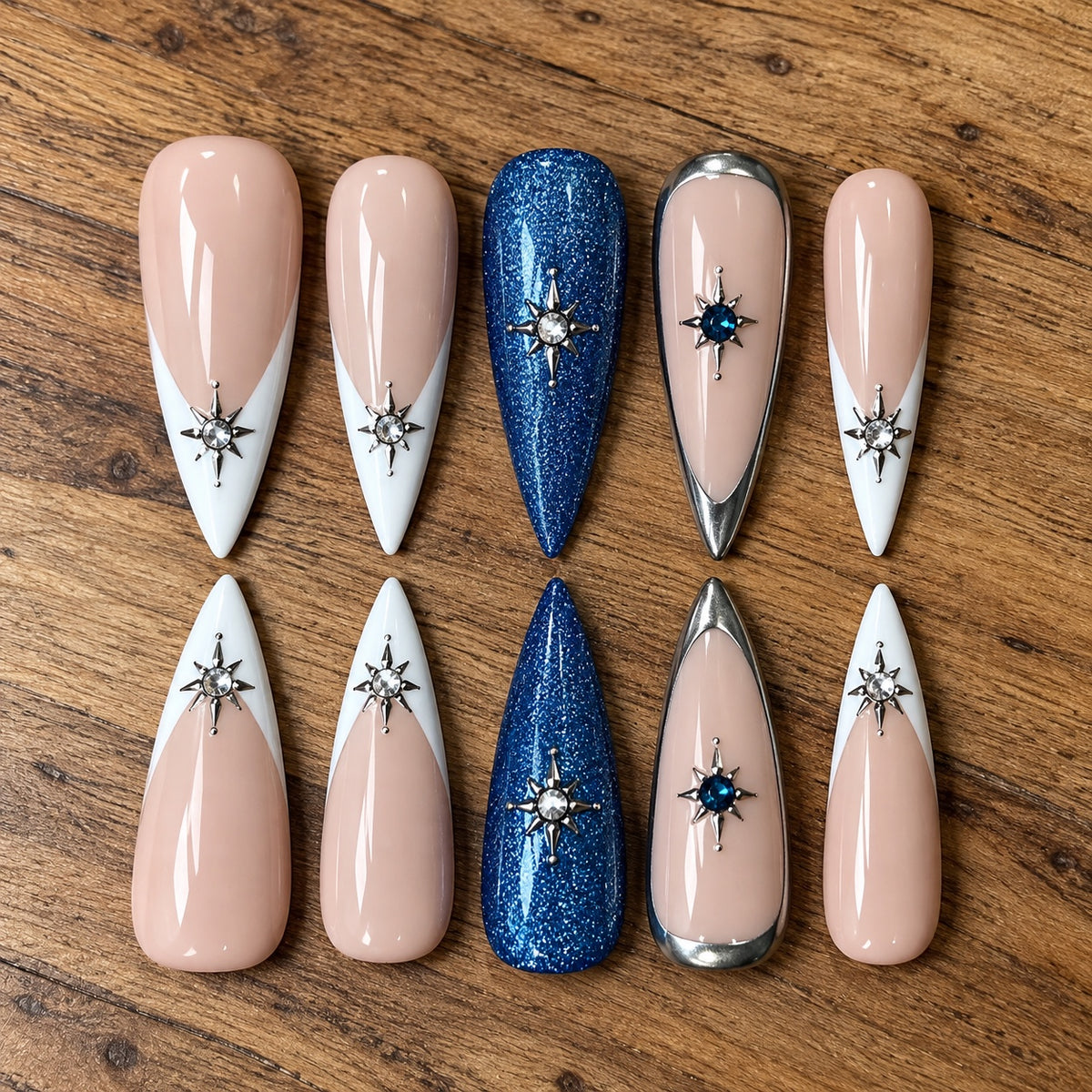 Under the Stars handmade press-on nails with nude, white French tips, blue glitter, silver chrome and starburst crystal accents